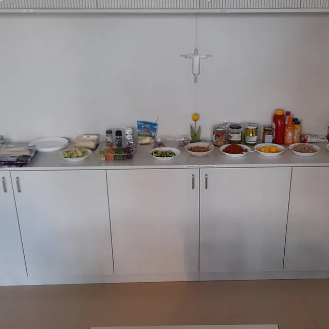 ein großes Buffet vor einer weißen Wand, in kleinen Schüsseln sind verschiedene Zutaten hergerichtet